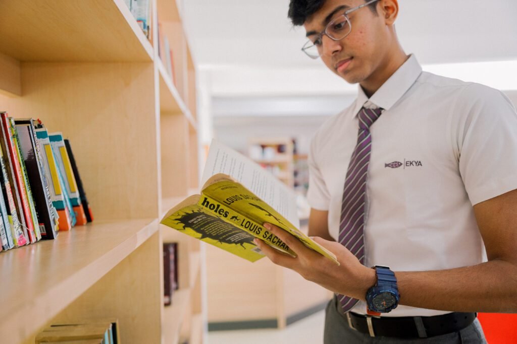 ib schools in bangalore ekya nava student reading book in library